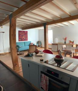 a living room with a kitchen and a living room with a table at Medieval Avignon, calm, stunning & spacious 60m2 in Avignon