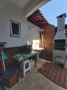 a room with a kitchen with a stove and a table at Sobrado novo in Florianópolis