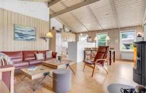 a living room with a couch and a table at Beautiful Home In Ebeltoft With Wifi in Ebeltoft