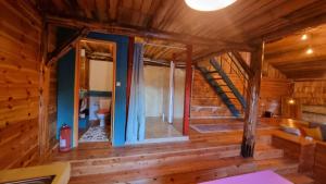 a room with a staircase in a log cabin at Harmonie Tree house Cotagges Chalet Predeal Trei Brazi in Predeal