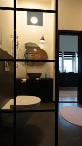 a glass door with a toilet in a room at Broncks Apartment 5 in Tórshavn
