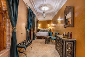 a hotel room with a bed and a mirror at Maïpa Boutique Riad in Marrakech