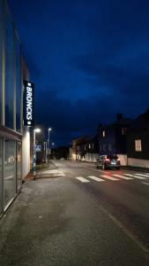a car is driving down a street at night at Broncks Apartment 5 in Tórshavn