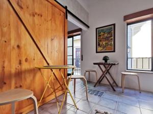 a room with a wooden wall and two chairs and a table at Downtown Apartment (center) in Setúbal +14 photos
