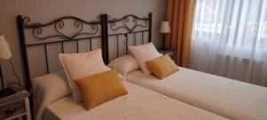 a bedroom with a bed with two pillows on it at LA GRANDA DE LA CONCHA in Nueva de Llanes