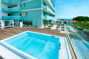 a swimming pool on the balcony of a building at Hotel Montecarlo in Bibione