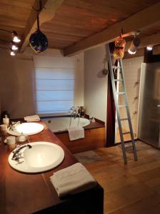 a bathroom with a sink and a ladder and a tub at Domaine d'Armagnac in Bessuéjouls
