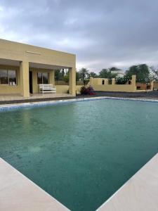 a swimming pool in front of a house at استراحه الليوان ALliwan Rak 1 in Ras al Khaimah