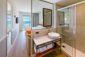 a bathroom with a sink and a shower at Hotel Montecarlo in Bibione