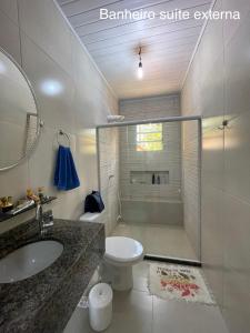 a bathroom with a sink and a toilet at Casa de Praia Ilhéus in Ilhéus