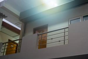 a building with a balcony with metal railing at Abbi Holiday Service Apartment in Jaffna