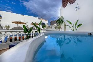 a swimming pool with a slide in a building at Maïpa Boutique Riad in Marrakech