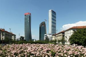 a field of pink flowers in front of buildings at Design Premium Apartment in Center Milan - HomeUnity in Milan
