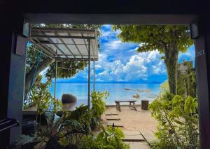a view of the ocean from a house with a view at The Parlour Krabi in Klong Muang Beach