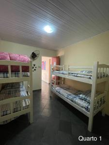 a room with three bunk beds in a room at Casa de Praia Ilhéus in Ilhéus