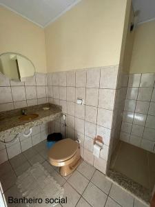 a bathroom with a toilet and a sink at Casa de Praia Ilhéus in Ilhéus