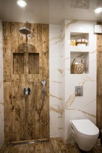 a bathroom with a toilet and a shower at Vazov Apartment in Kazanlŭk