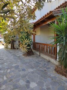 a porch of a house with trees and a patio at Olive Garden Loft Apartment in Kokkari