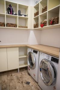 a laundry room with a washer and dryer at Vazov Apartment in Kazanlŭk