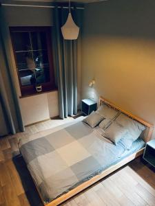 a large bed in a bedroom with a window at Penzion Rima in Zuberec
