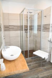 een badkamer met een witte wastafel en een douche bij AFFITTACAMERE VAL SUSA in San Didero 