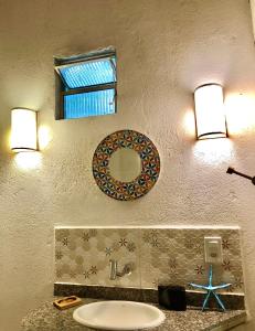 a bathroom with a sink and a mirror on the wall at Gaia Eco Glamping - Instituto Almas Livres in Arraial d'Ajuda