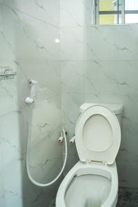 a white bathroom with a toilet and a shower at Live By The Water 2-Bed-Apt With FAST Wi-Fi And Secured in Amuwo