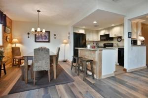 an open kitchen and dining room with a table and chairs at Seven Springs 3 Bedrooms Premium Condo, Ski In Ski Out condo in Champion