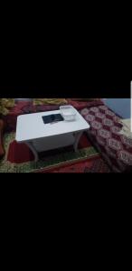 a white table sitting on top of a rug at El barandilla in Sidi Ifni