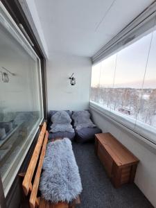 a room with couches and a window with a view at Topelius Park Apartment in Uusikaarlepyy