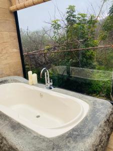 a white sink in a bathroom with a window at Finca maestra in Los Llanos