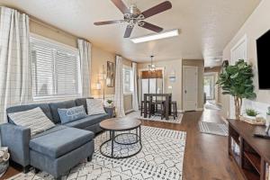 a living room with a blue couch and a table at Smart Comfort 2 bed 2 bath near College of Idaho in Caldwell