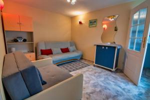 a living room with a couch and a chair at Domek u Janiny in Czaplinek