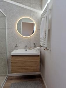 a bathroom with a sink and a mirror at Duplex type chalet dans le Jura in Morbier