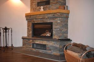 a brick fireplace with a tv on top of it at Chata Svojáč in Svojanov