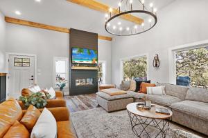 a living room with a couch and a fireplace at Barndo on the Blanco in Wimberley