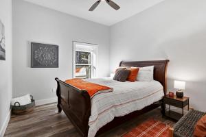 a bedroom with a bed with an orange blanket at Barndo on the Blanco in Wimberley