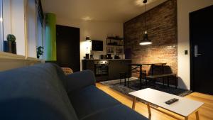a living room with a couch and a table at Broncks Apartment 2 - Modern 2-Bedroom in the Heart of Tórshavn in Tórshavn