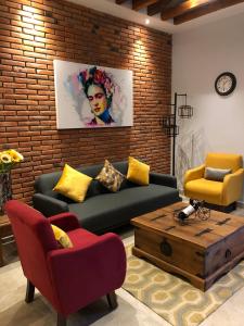a living room with a couch and a coffee table at Doña Jose Suite & Apartments in San Miguel de Allende