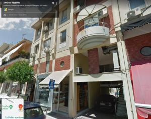 a building with a balcony on the side of a street at CLIC - Comfort Luxury in City of Ioannina in Ioannina