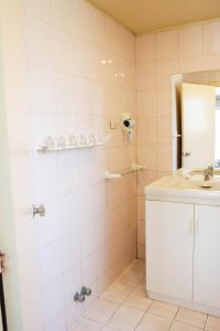 W łazience znajduje się prysznic, umywalka i lustro. w obiekcie Hotel Rondó w mieście Viña del Mar