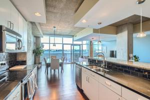 a large kitchen with a table and a dining room at 1700 Bassett, Unit 818 in Denver