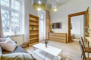 een woonkamer met een bank en een tafel bij Kamienica Centrum Apartament nr 3 in Szczecin