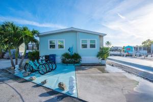 a blue house with bikes parked in front of it at OCEANIA... water front cottage retreat ~ in Cudjoe Key