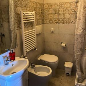 a small bathroom with a sink and a toilet at B&B Ai Glicini - Castelli Romani in Marino
