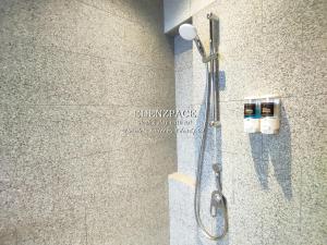 a shower in a bathroom with a shower head at Scarletz Suites by Edenzpace @ KLCC Area in Kuala Lumpur