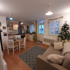 a living room with a couch and a christmas tree at The Hideaway in Swanage