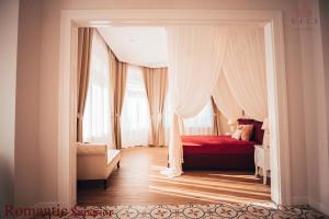 - une chambre avec un lit rouge et une fenêtre dans l'établissement Vili Apartments, à Oradea
