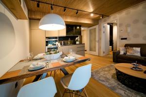 a kitchen and living room with a table and chairs at Molo-Lipno Residence B202 in Lipno nad Vltavou