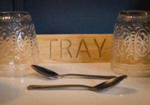 two spoons and a sign that says pray on a table at Ye Olde Smugglers Inne in Alfriston